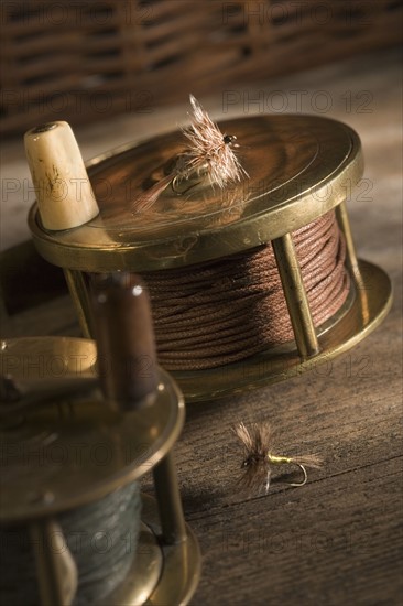 Still life of antique fishing reels.