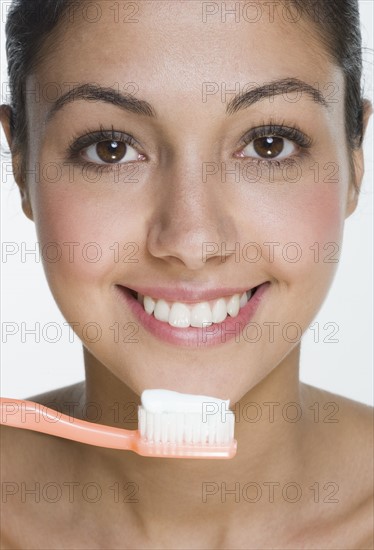 Smiling woman with toothbrush.