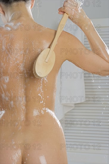 Rear view of woman bathing.