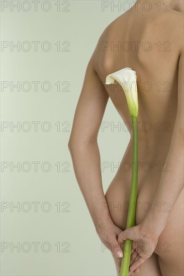 Nude female with calla lily.