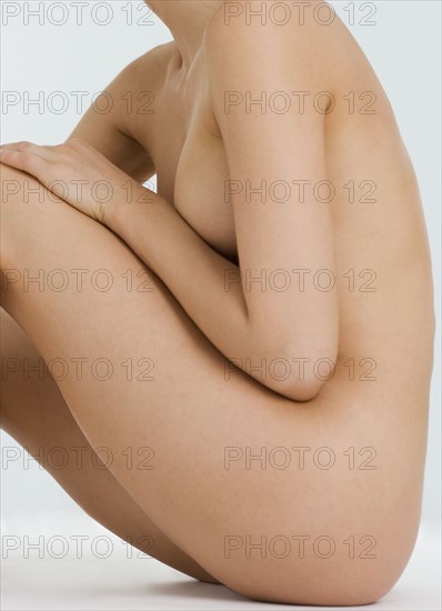 Profile of seated nude female.