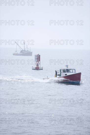 Lobster boat in fog off the Maine coast.