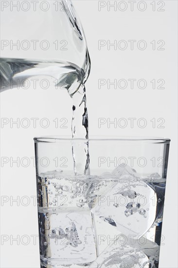 Pouring a glass of ice water.
