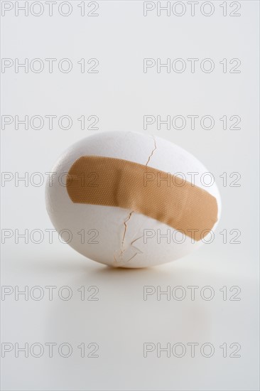 Cracked egg with bandage.