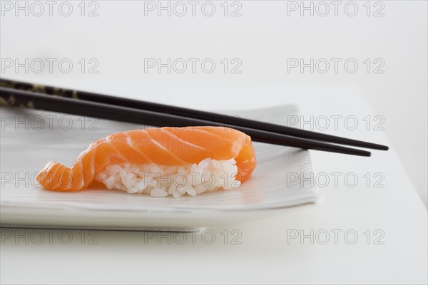 Sushi with chopsticks.