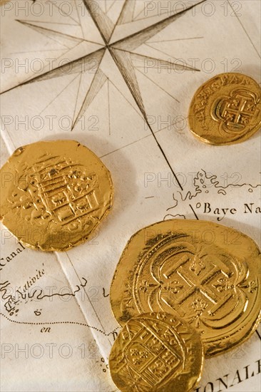 Still life of pieces of gold and map.