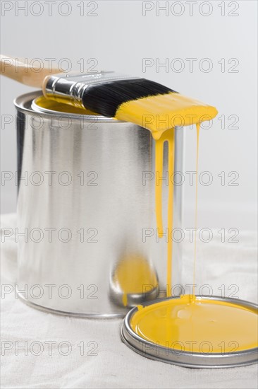 Still life of paint brush with yellow paint.