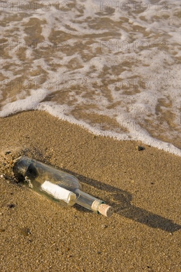 Message in a bottle on beach.