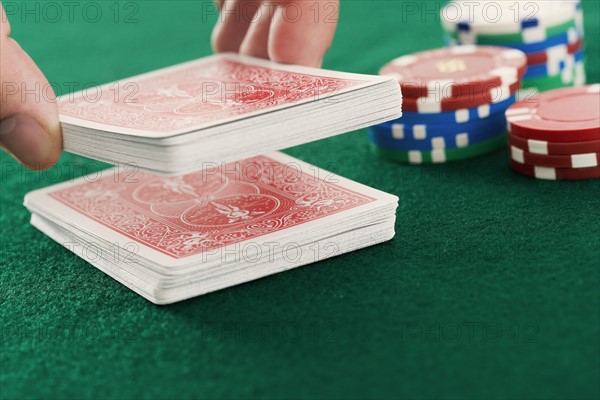 Cutting cards on poker table.