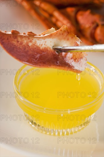 Dipping lobster in melted butter.