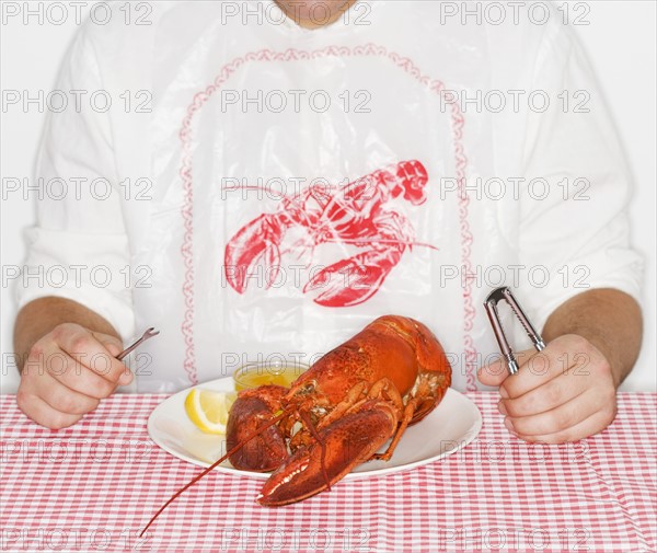 Man eating a lobster.