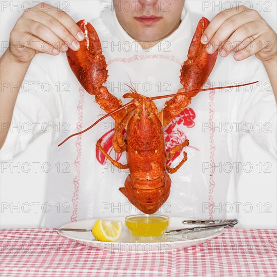 Man dining with an entire lobster.