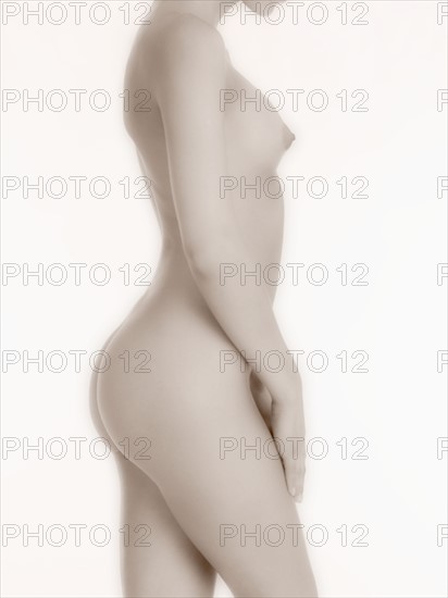 Nude woman in profile.