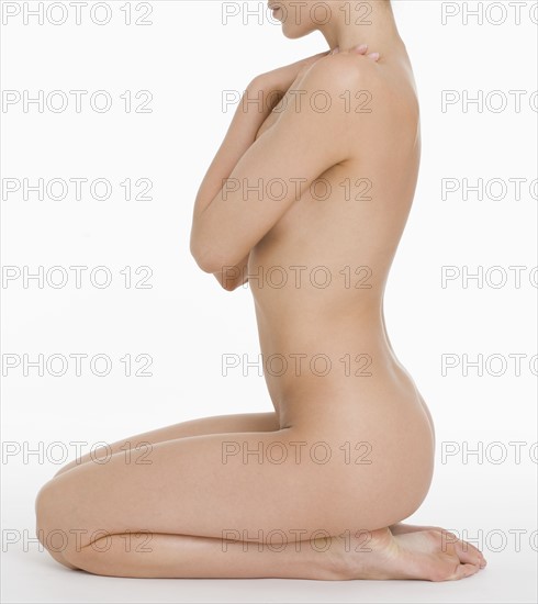 Profile of seated nude female.