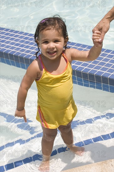Girl standing in swimming pool.