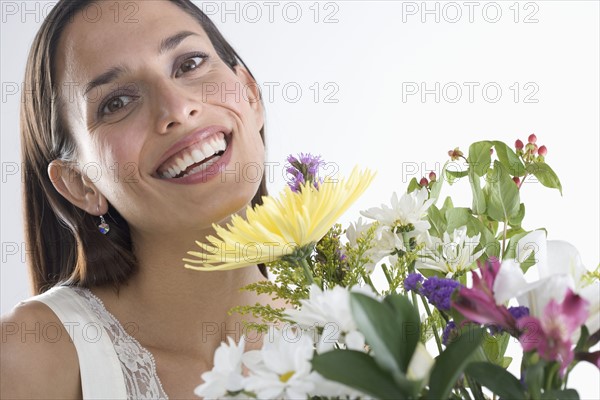 Woman holding bouquet of flowers.