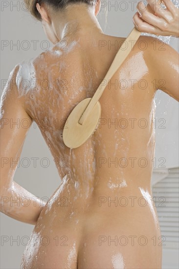 Rear view of woman bathing.