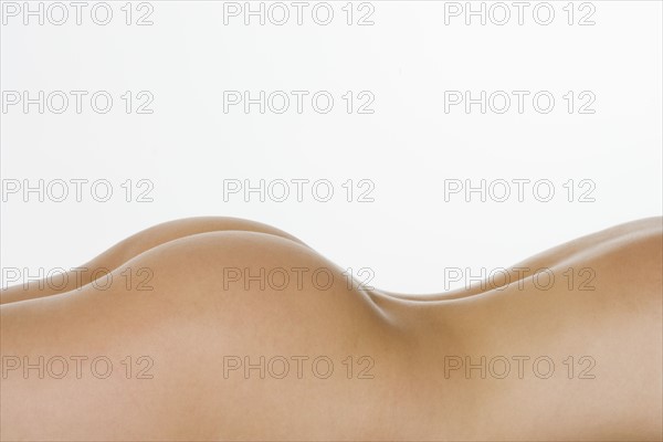 Closeup of nude female posterior.