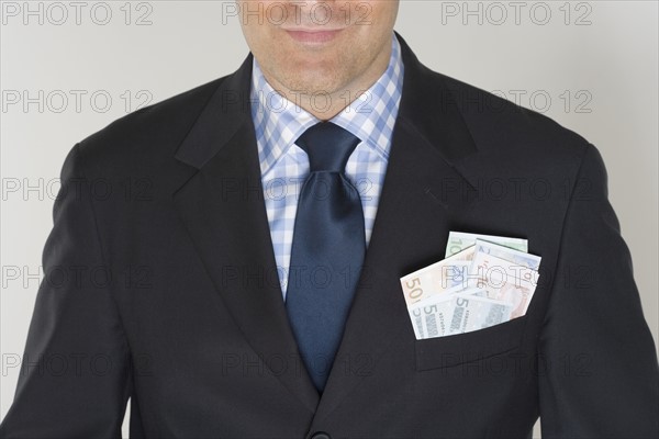 Man with a pocketful of Euros.