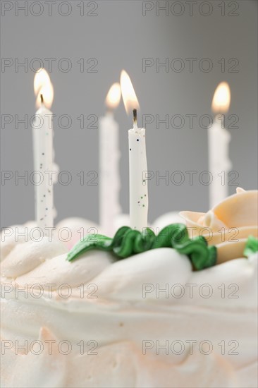 Lit candles on a birthday cake.