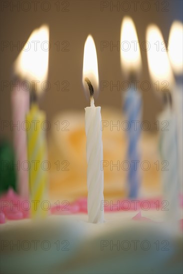 Lit candles on a birthday cake.