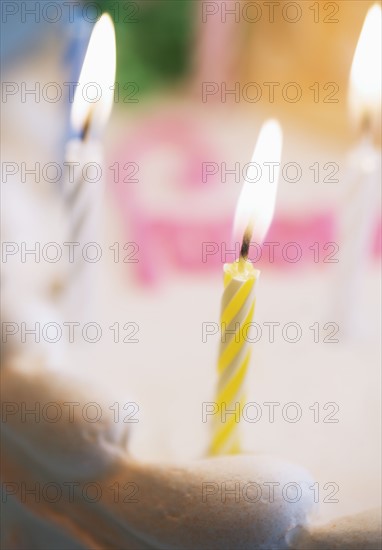 Lit candles on a birthday cake.