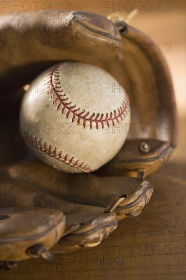 Still life of a baseball glove and ball.