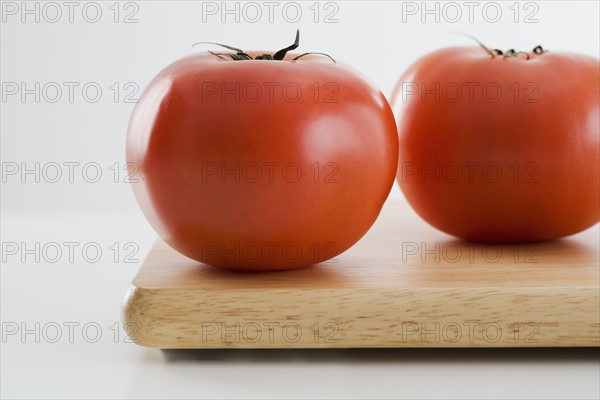 Tomatoes on cutting board.