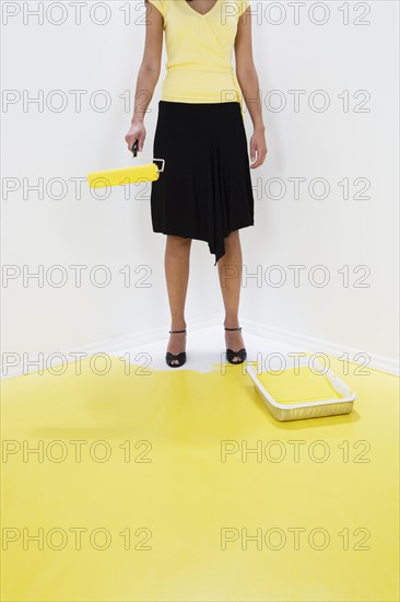 Woman painting herself into a corner.