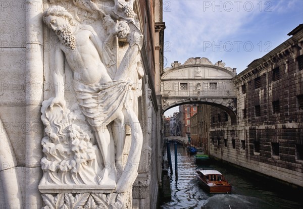 The Bridge of Sighs with sculpture depicting Drunkenness of Noah Doge's Palace Venice, Italy.