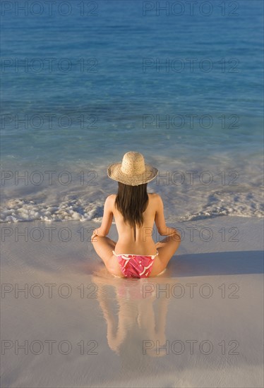 Woman sitting on beach.