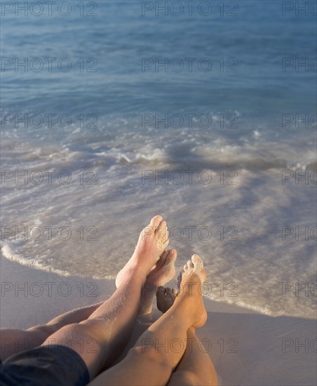 Couple relaxing on beach.