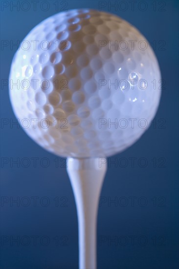 Closeup of golf ball on tee.