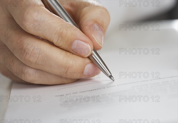 Closeup of hand writing with pen.