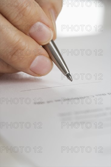 Closeup up of fingers with pen.