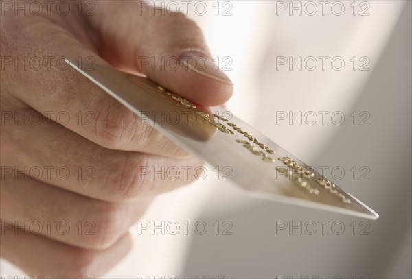 Closeup of hand holding credit card.