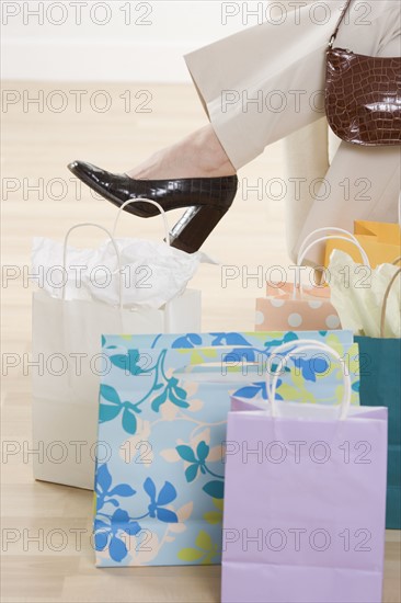 Woman's leg with shopping bags.