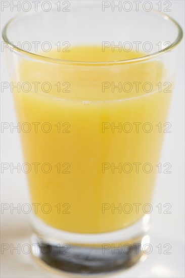 Closeup of glass of orange juice.