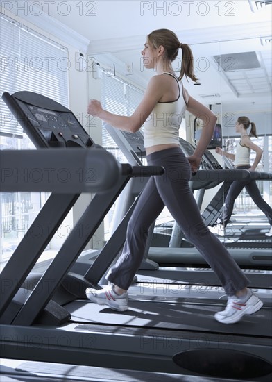 Woman working out on treadmill.