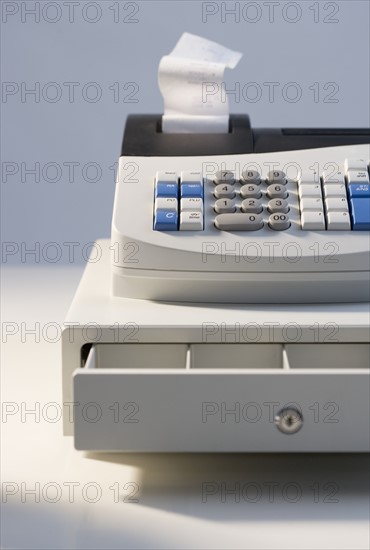 Cash register with open drawer.