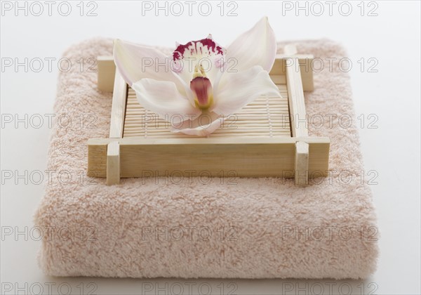 Still life of orchid on terry cloth.