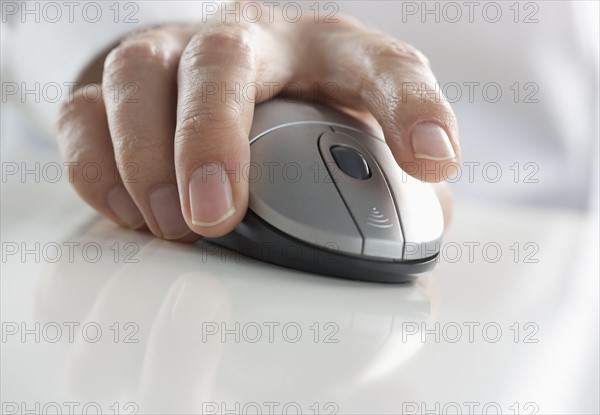 Closeup of hand pressing mouse button.