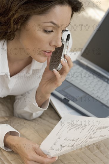 Woman with mobile phone and computer.