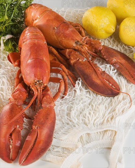 Still life of lobsters and lemons.