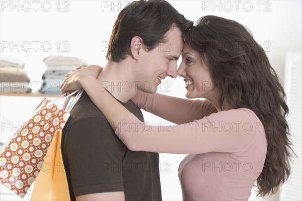 Couple embracing with foreheads touching.