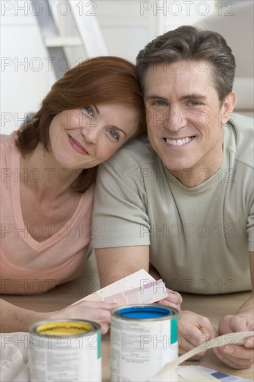 Couple with paint and color samples.