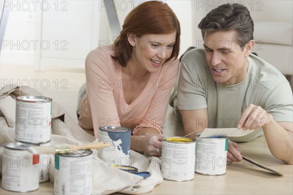 Couple discussing paint color choices.