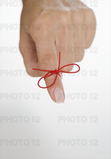 String tied around woman's finger.