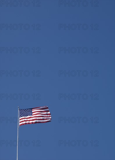 American flag against blue sky.