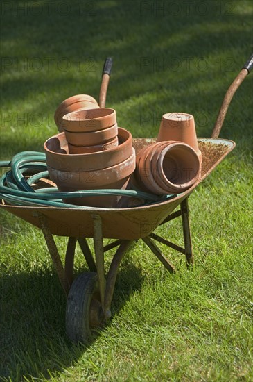 Wheelbarrow and gardening tools.